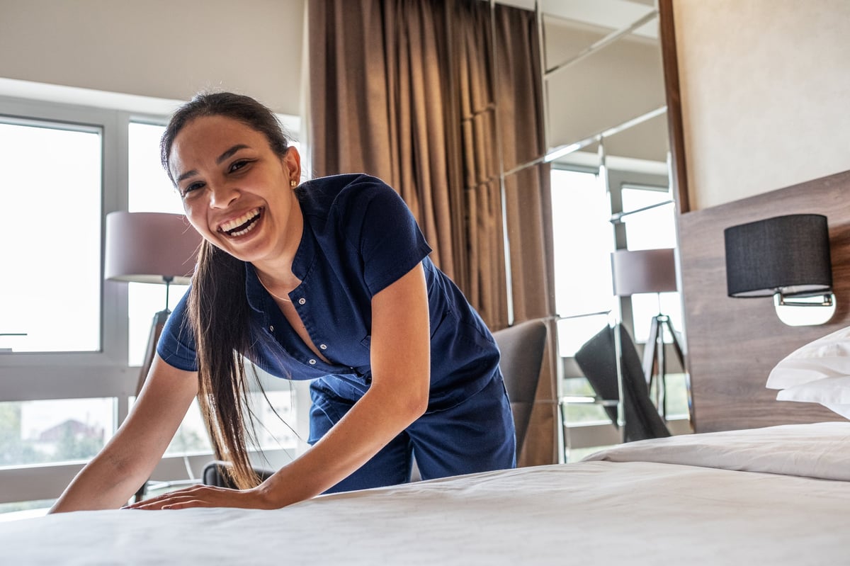 Staff member preparing a room ready for the next guests
