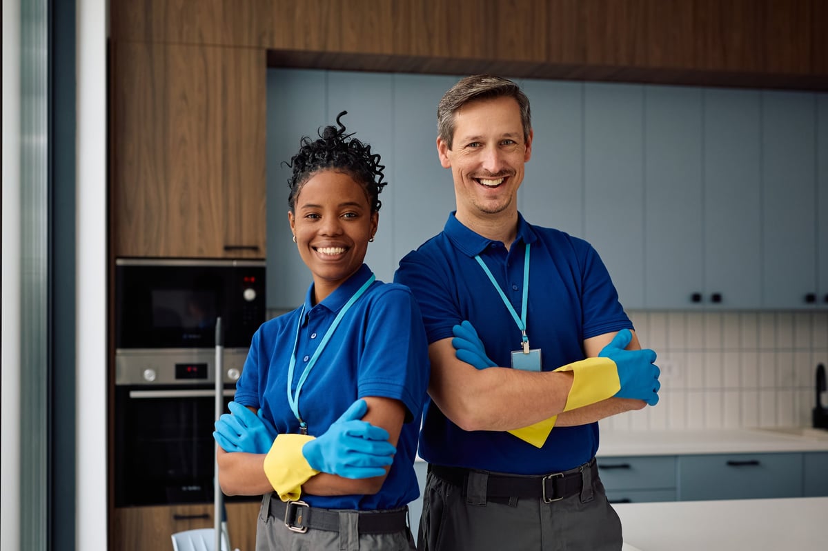 Professional cleaning team standing together with arms crossed